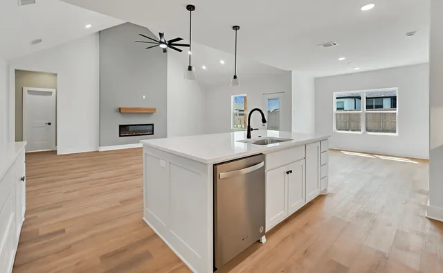 a kitchen with a sink stove and cabinets