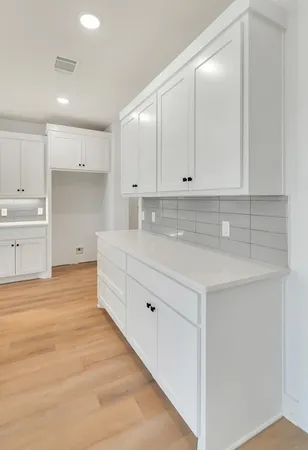 a kitchen with white cabinets