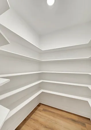 a empty closet with wooden floor