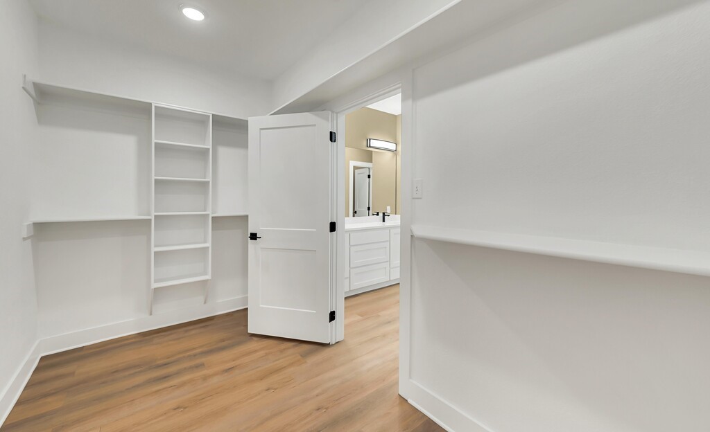 9904 Ridings Drive Waco, TX 76708 - Photo 26 of 37 a view of an empty room with cabinet and wooden floor