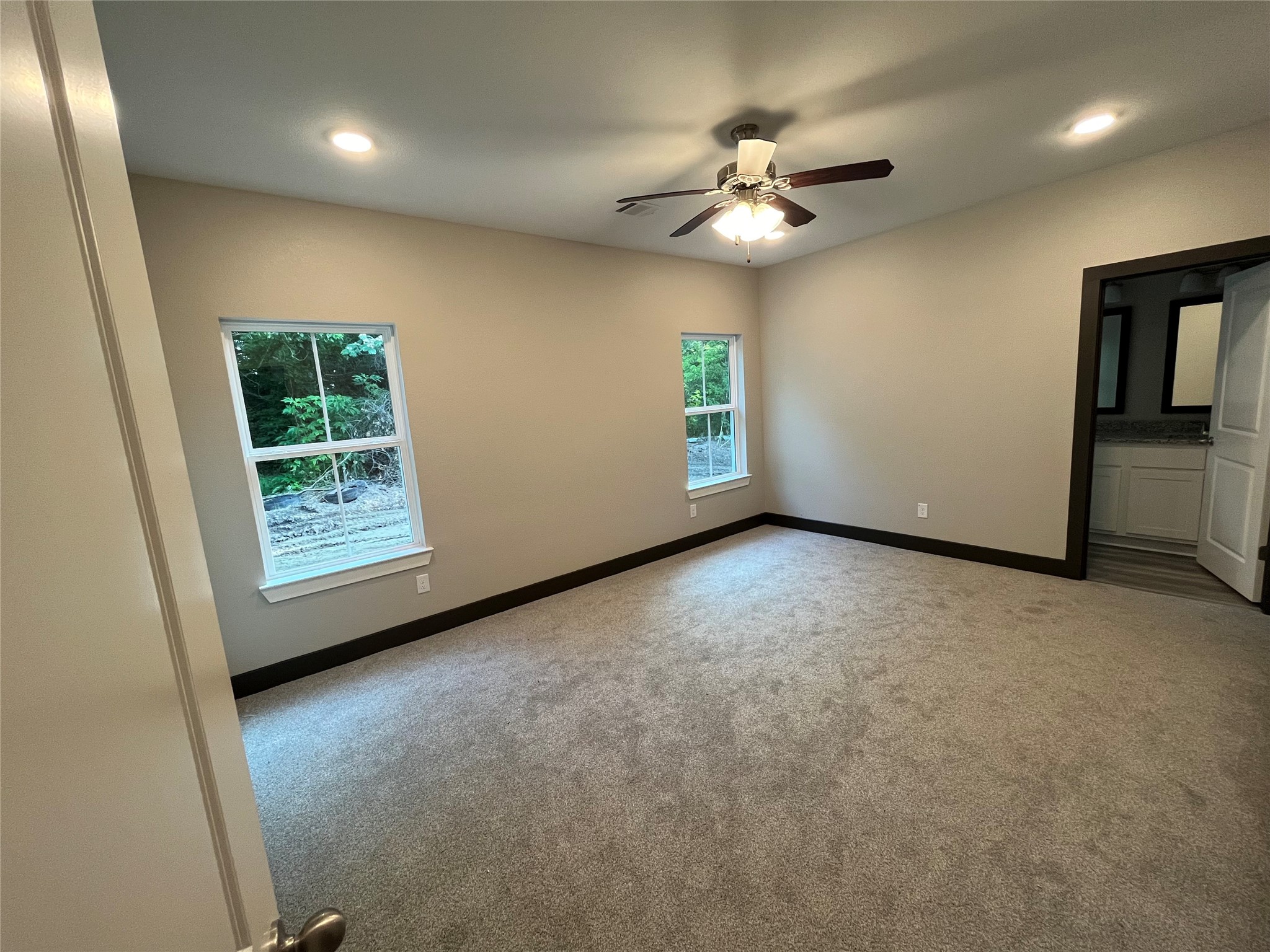 111 Heatherbrook Somerville, TX 77879 - Photo 5 of 11 an empty room with windows and fan