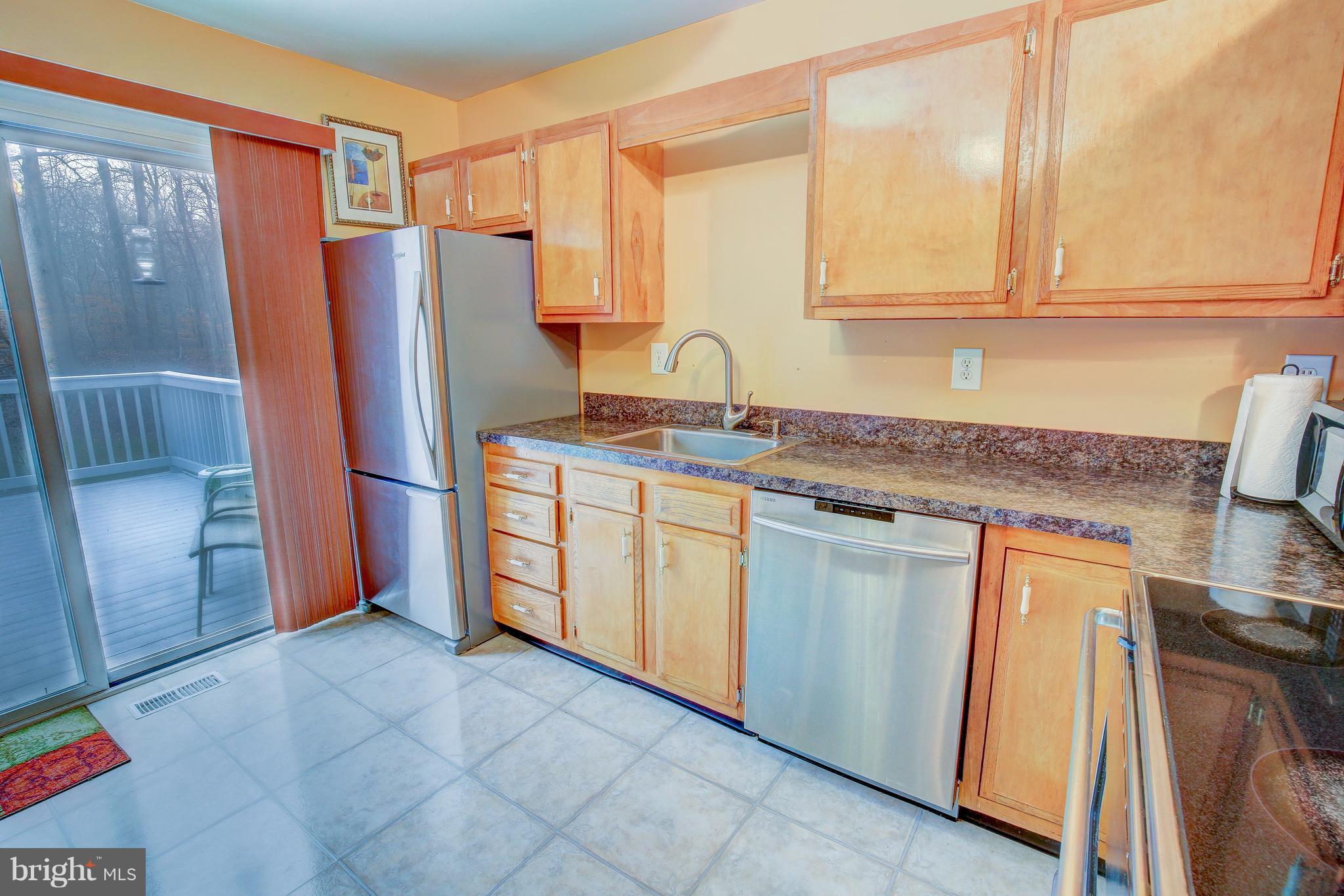 265 Chesapeake Beach Road Owings, MD 20736 - Photo 12 of 30 a kitchen with stainless steel appliances granite countertop a refrigerator and a stove top oven