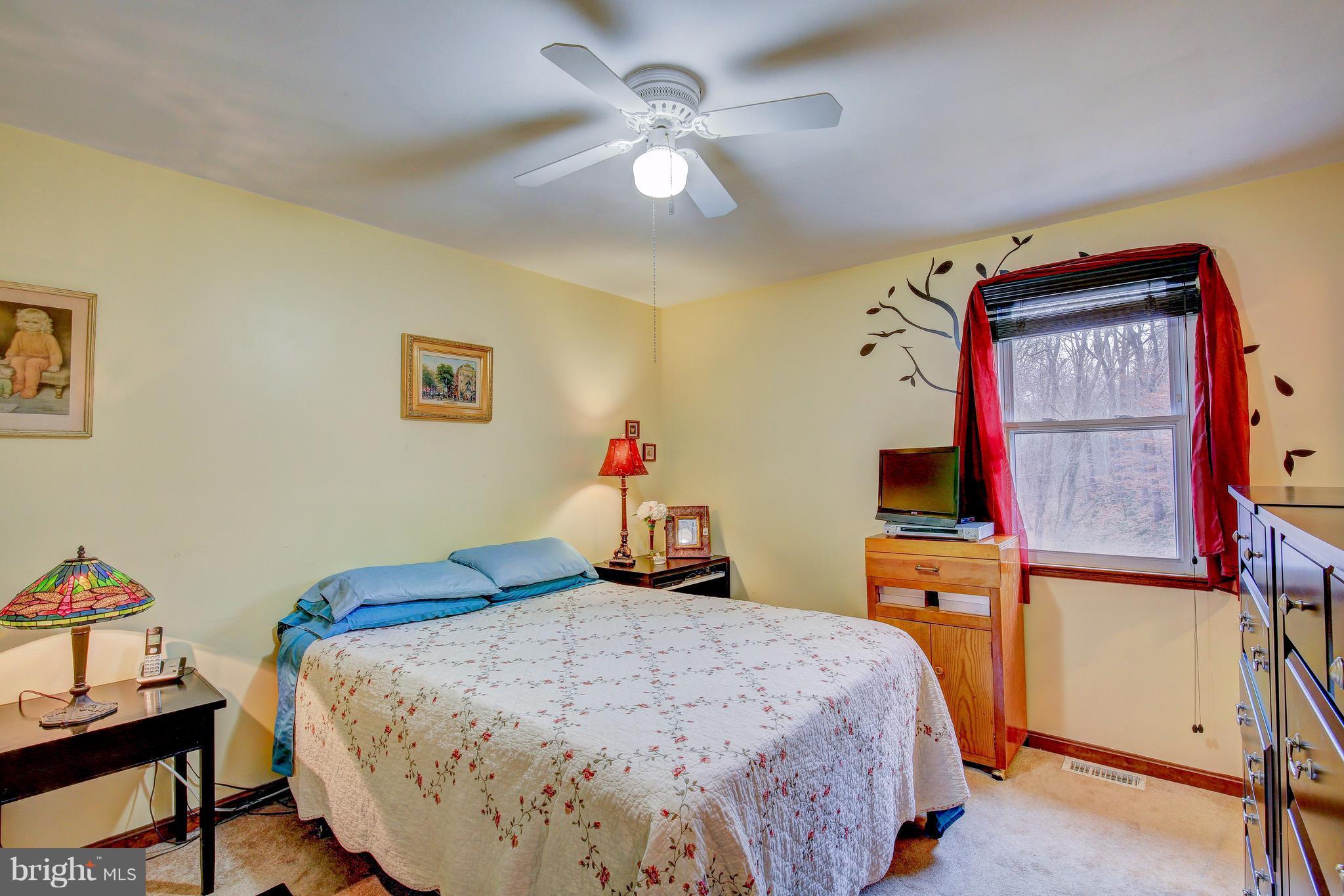 265 Chesapeake Beach Road Owings, MD 20736 - Photo 18 of 30 a bedroom with a bed and a dresser