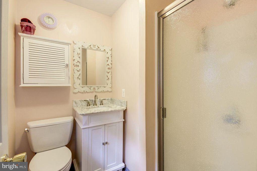265 Chesapeake Beach Road Owings, MD 20736 - Photo 20 of 30 a bathroom with a toilet a sink and a mirror