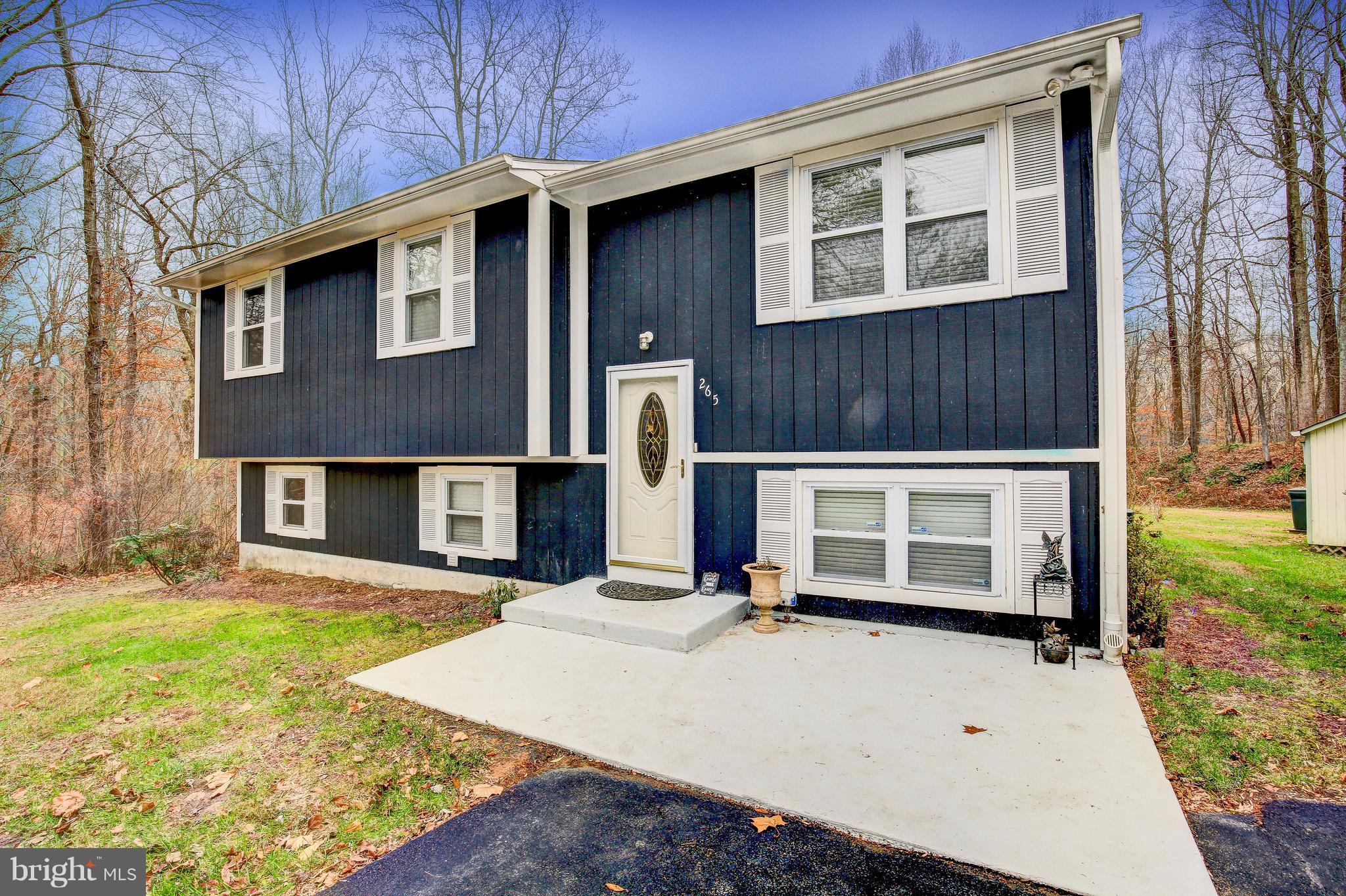 265 Chesapeake Beach Road Owings, MD 20736 - Photo 3 of 30 a front view of a house with a yard
