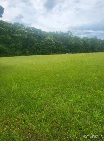 a view of a green field with clear sky