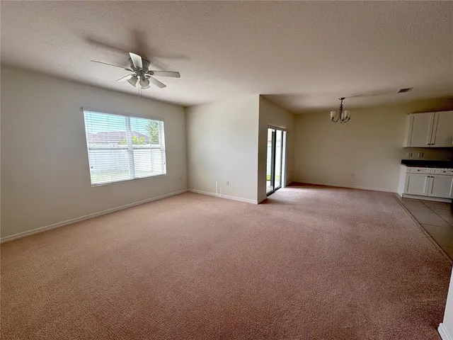a view of a livingroom with a ceiling fan and window
