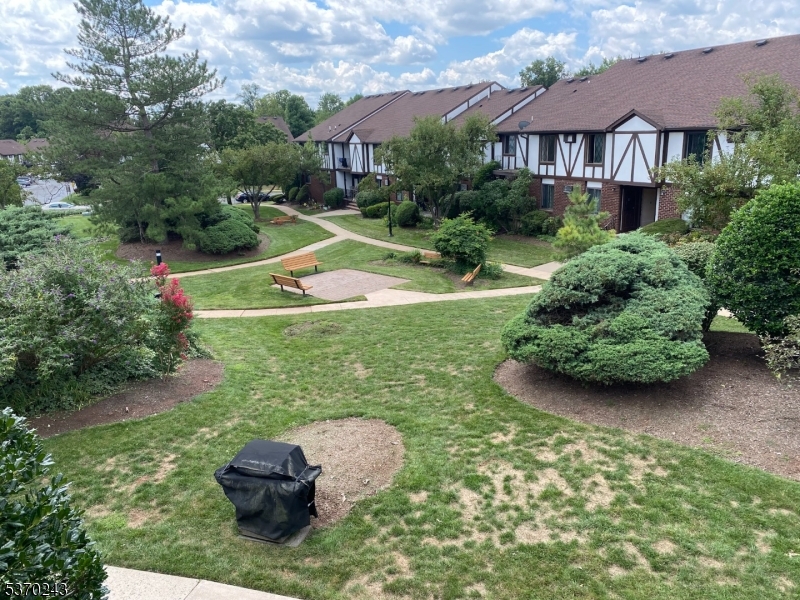 73 Farm Road Hillsborough, NJ 08844 - Photo 20 of 26 a view of a house with a yard and potted plants