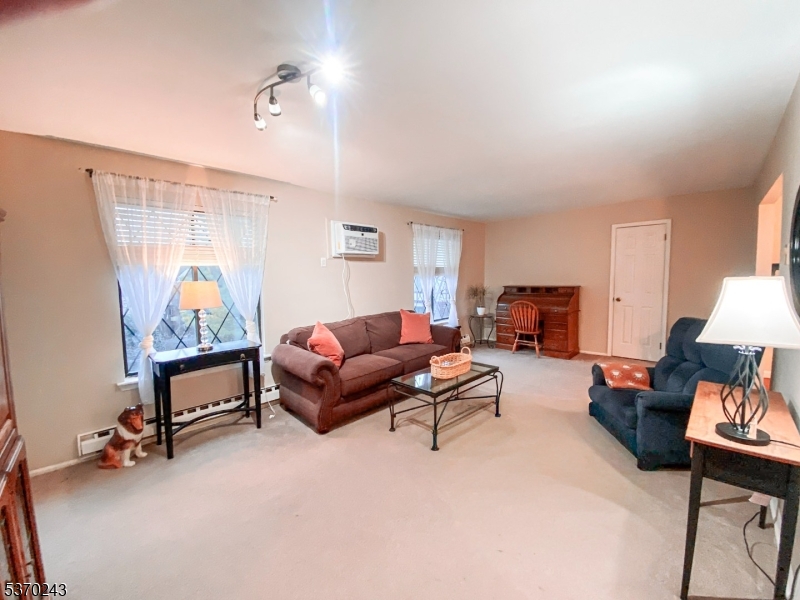 73 Farm Road Hillsborough, NJ 08844 - Photo 4 of 26 a living room with furniture gym equipment and a window