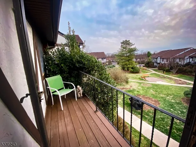 a view of balcony with wooden floor and outdoor seating