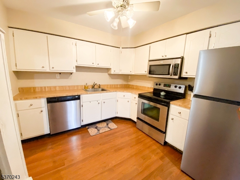 73 Farm Road Hillsborough, NJ 08844 - Photo 10 of 26 a kitchen with stainless steel appliances a refrigerator sink and white cabinets