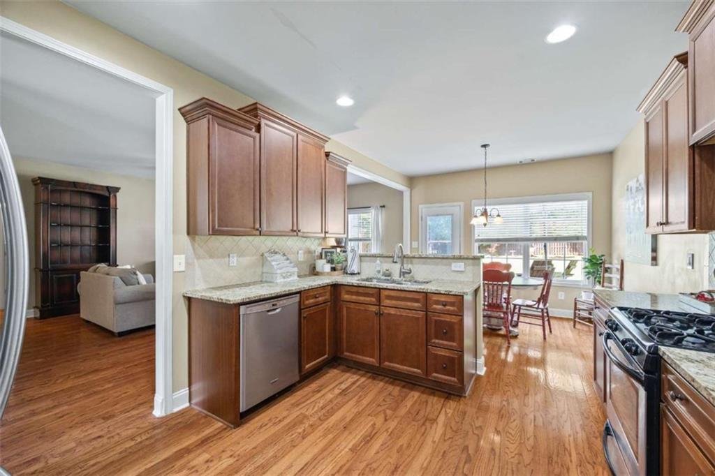 42 Pintail Lane Jefferson, GA 30549 - Photo 5 of 42 a kitchen with stainless steel appliances granite countertop wooden cabinets a sink dishwasher a stove and a refrigerator