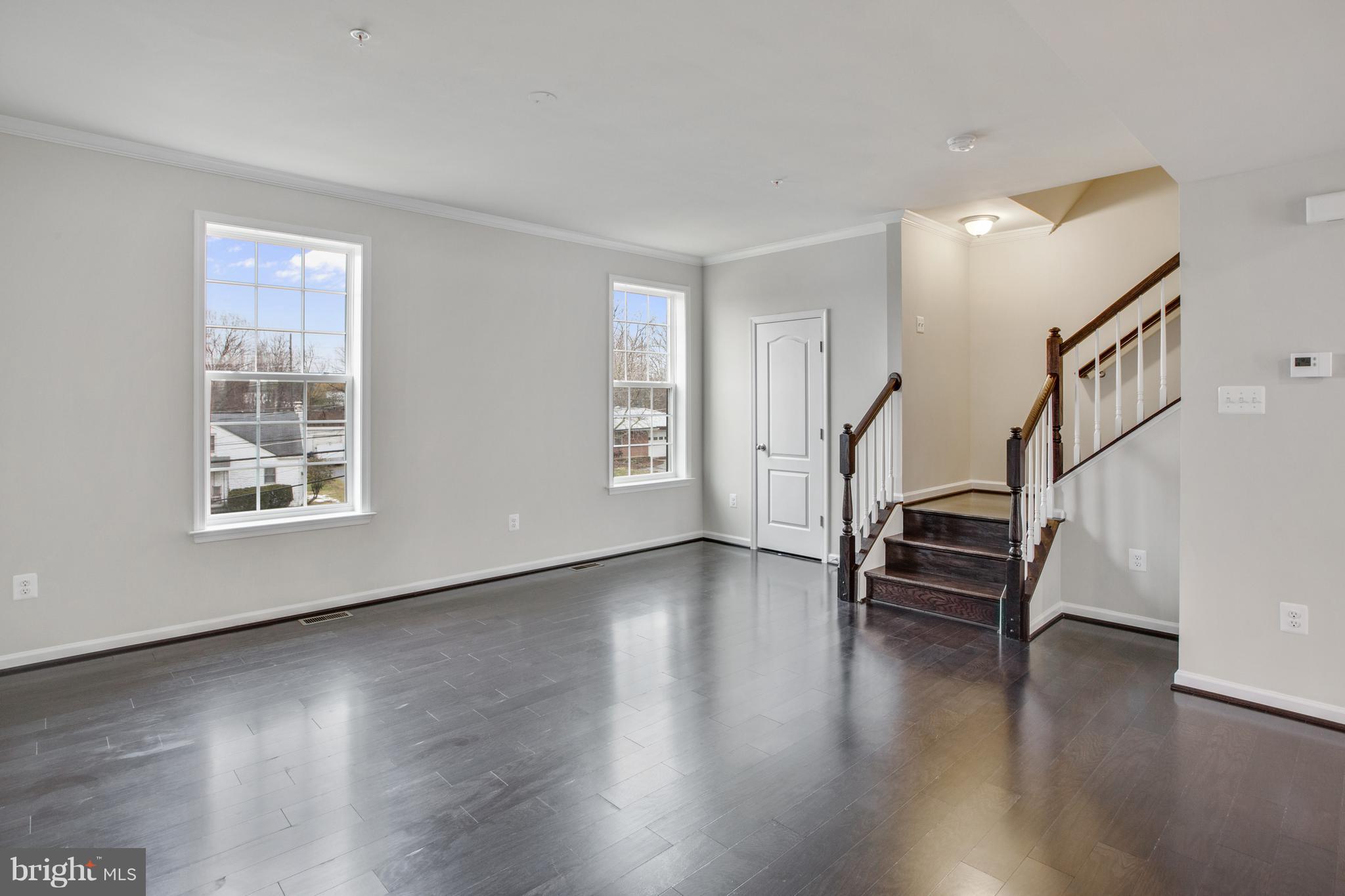 7871 Wormans Mill Road Frederick, MD 21701 - Photo 12 of 30 a view of an empty room with wooden floor and a window