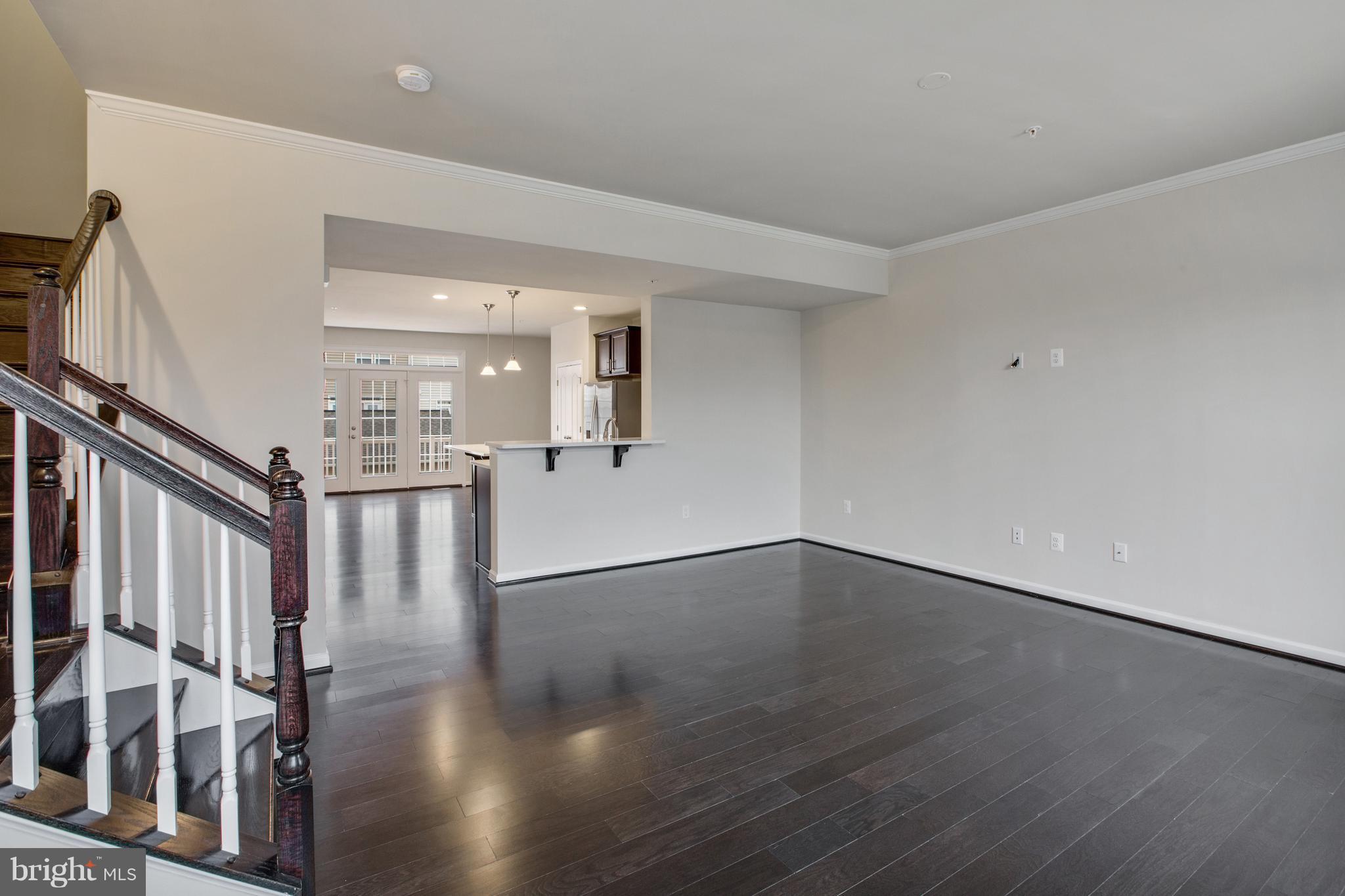 7871 Wormans Mill Road Frederick, MD 21701 - Photo 14 of 30 a view of an empty room with wooden floor and a window