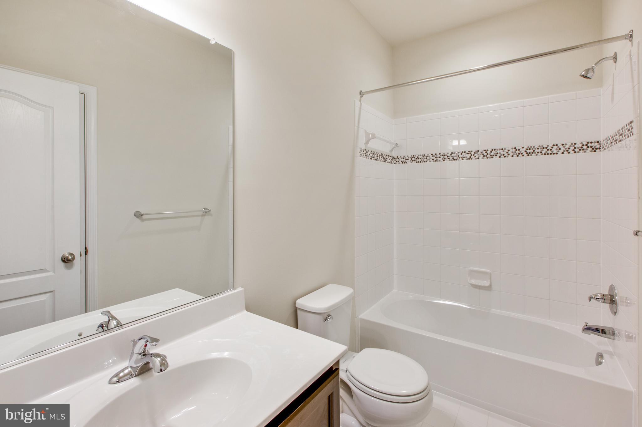 7871 Wormans Mill Road Frederick, MD 21701 - Photo 24 of 30 a bathroom with a sink toilet and shower