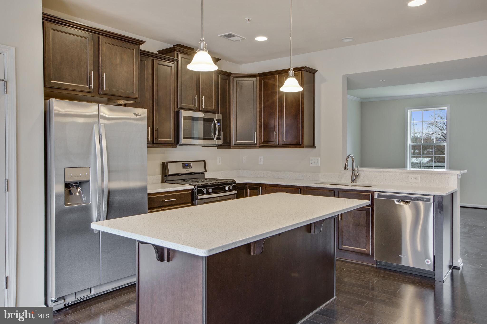 7871 Wormans Mill Road Frederick, MD 21701 - Photo 9 of 30 a kitchen with kitchen island a sink stove and refrigerator