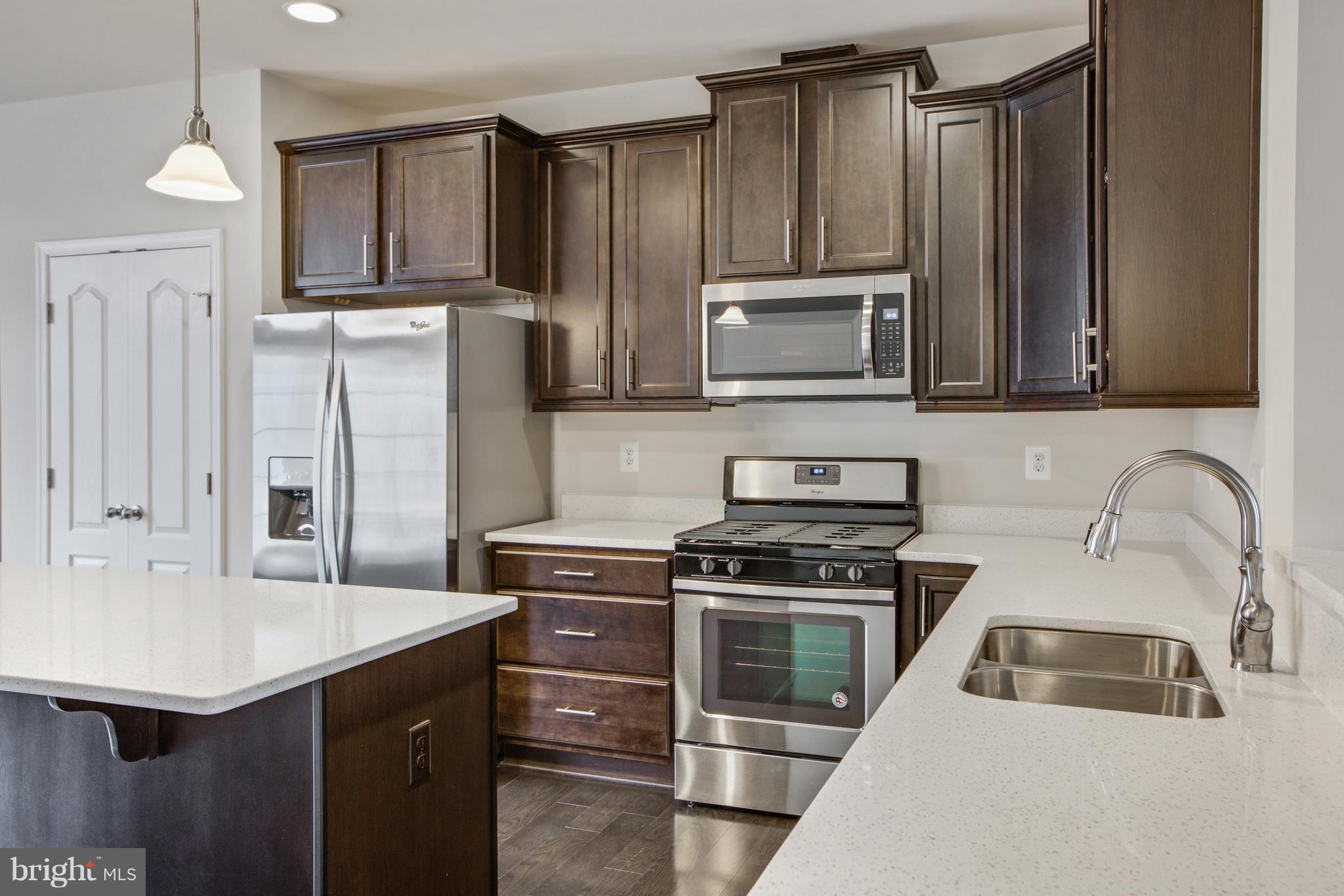 7871 Wormans Mill Road Frederick, MD 21701 - Photo 10 of 30 a kitchen with appliances a sink a stove and cabinets