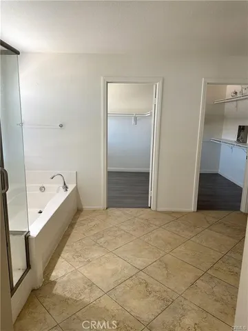 a bathroom with a bathtub and a shower