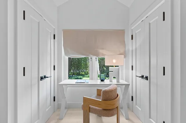 a bathroom with a granite countertop sink and a large mirror