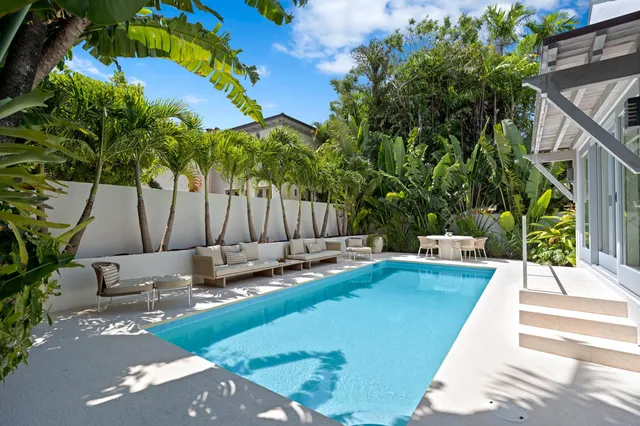 a view of a backyard with swimming pool