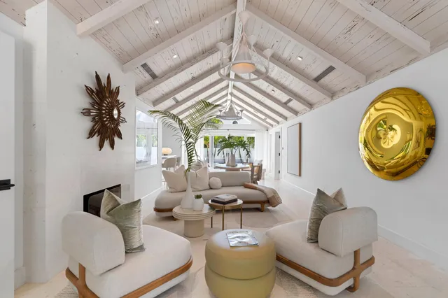 a living room with fireplace furniture and a chandelier