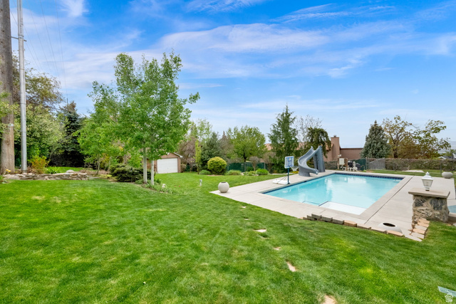 1506 Lakeview Drive Bountiful, UT 84010 - Photo 52 of 58 View of pool featuring a water slide, patio surround, and an outdoor structure