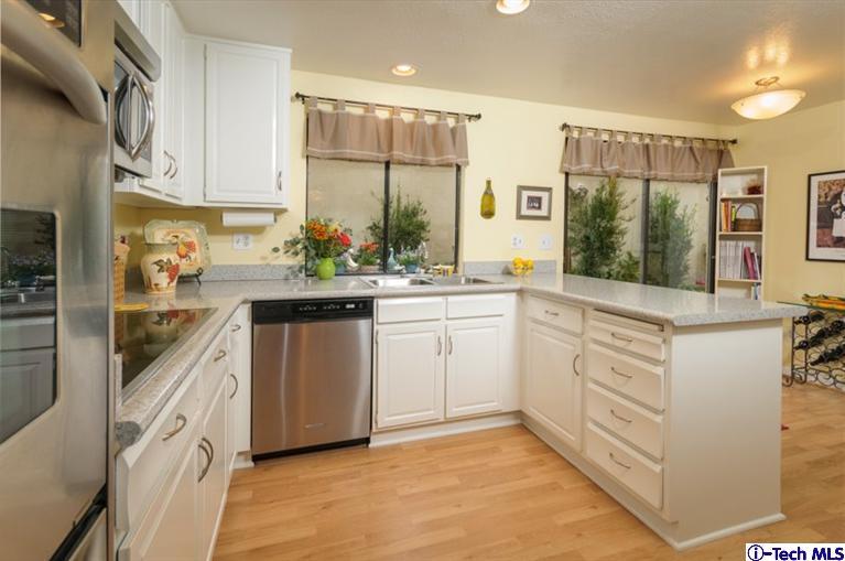 1445 Valley View Road, Unit 5 Glendale, CA 91202 - Photo 13 of 19 a kitchen with white cabinets and white appliances