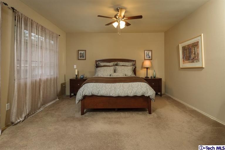 1445 Valley View Road, Unit 5 Glendale, CA 91202 - Photo 15 of 19 a bedroom with a bed and a chandelier