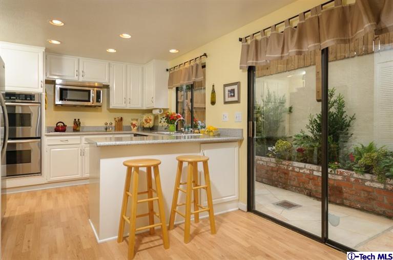 1445 Valley View Road, Unit 5 Glendale, CA 91202 - Photo 3 of 19 a kitchen with stainless steel appliances granite countertop a sink and cabinets