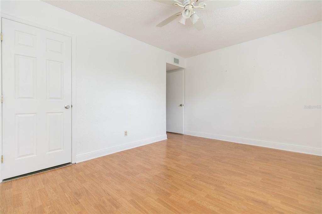 7531 Abonado Road, Unit 1 Tampa, FL 33615 - Photo 18 of 26 an empty room with a chandelier fan