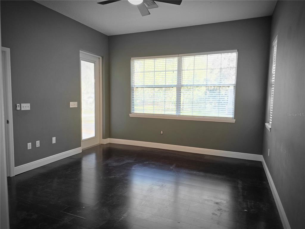 27410 Yalaha Cut Off Road Yalaha, FL 34797 - Photo 11 of 22 an empty room with wooden floor and windows
