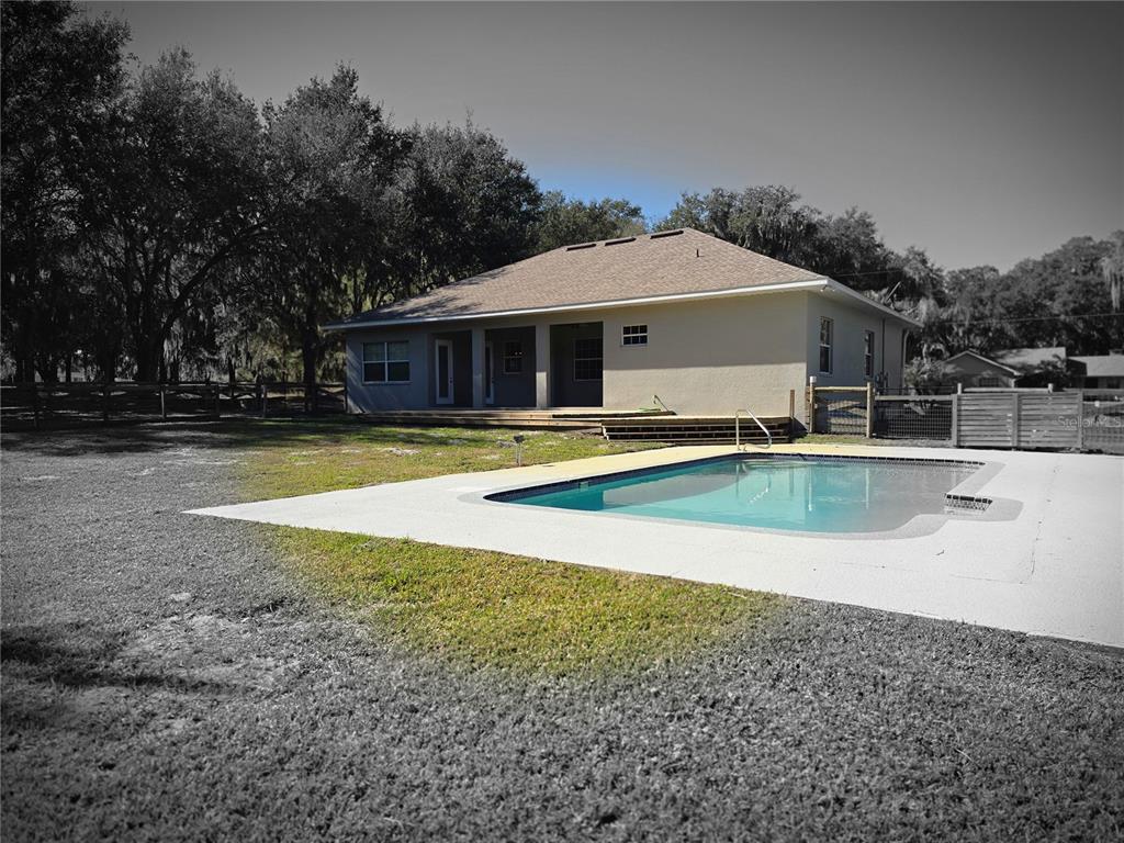 27410 Yalaha Cut Off Road Yalaha, FL 34797 - Photo 19 of 22 a view of a house with swimming pool