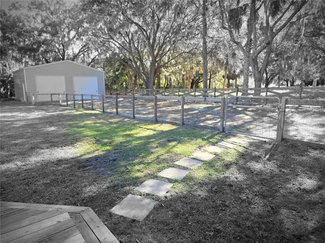 a view of yard with tree in the background