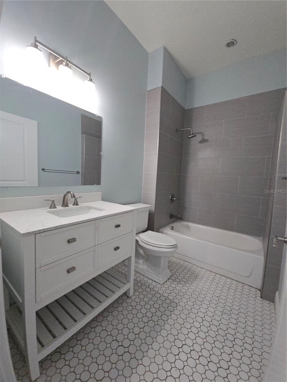 27410 Yalaha Cut Off Road Yalaha, FL 34797 - Photo 8 of 22 a bathroom with a double vanity sink toilet and shower