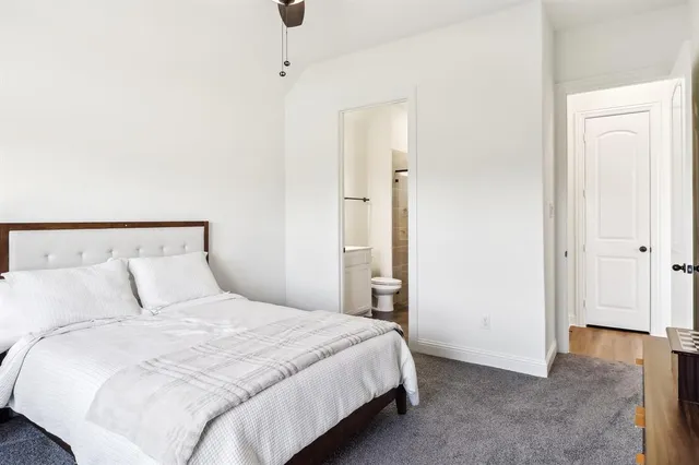 a bedroom with a bed and a painting