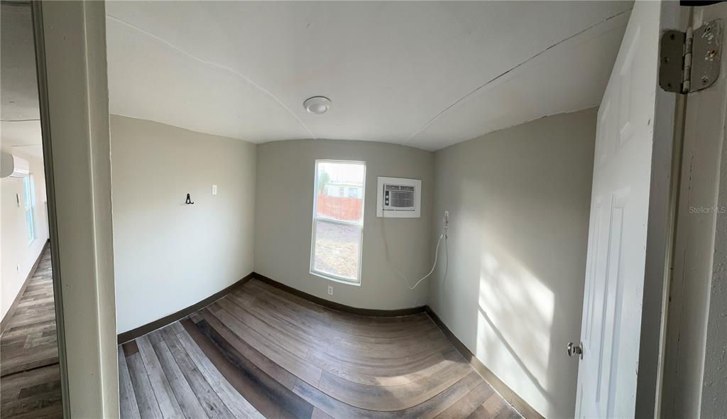 16083 Naples Street Brooksville, FL 34604 - Photo 14 of 16 an empty room with windows