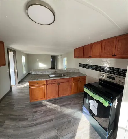 a bathroom with a granite countertop toilet a sink and a bathtub
