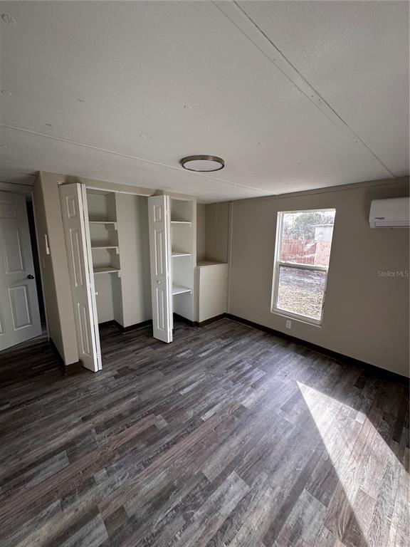 16083 Naples Street Brooksville, FL 34604 - Photo 6 of 16 a view of empty room with wooden floor and window