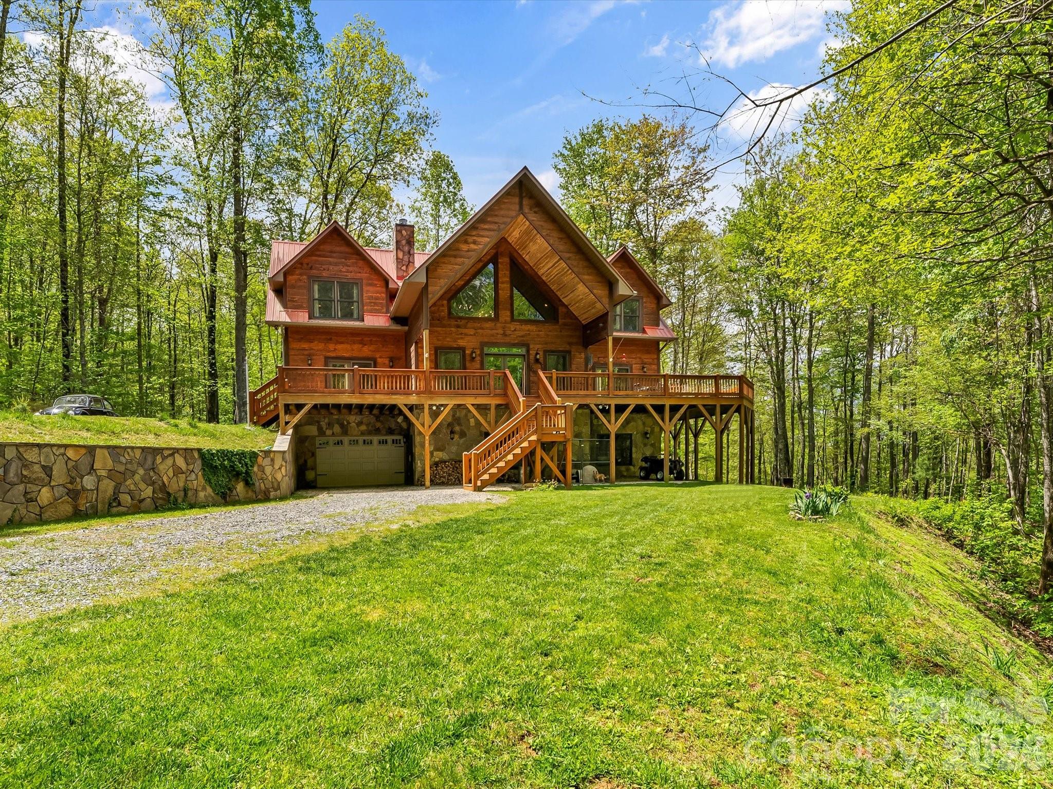 917 Otter Mountain Road Topton, NC 28781 - Photo 4 of 48 a front view of a house with a yard and garage