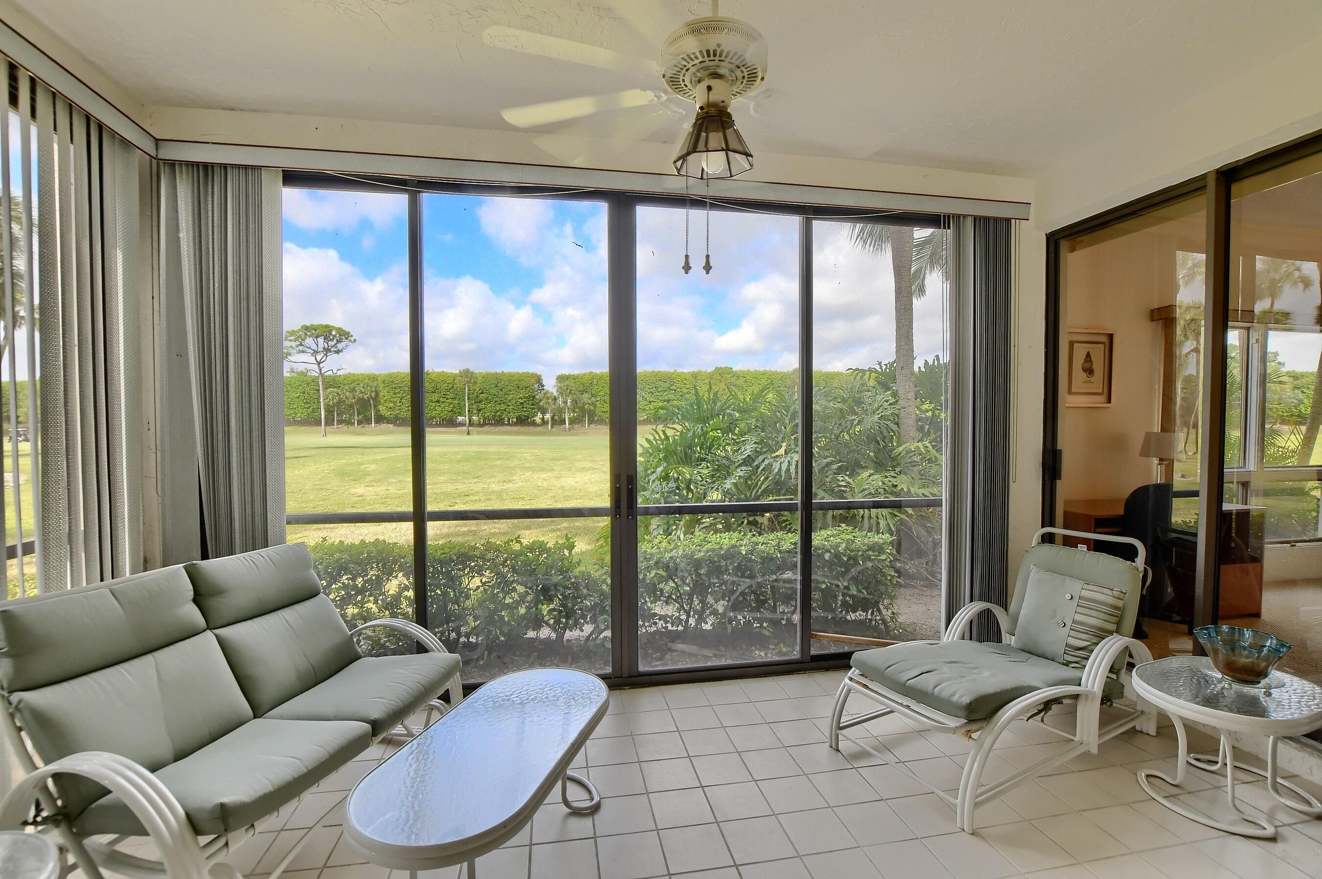 7896 Seville Place, Unit 1501 Boca Raton, FL 33433 - Photo 14 of 32 a living room with furniture and floor to ceiling windows