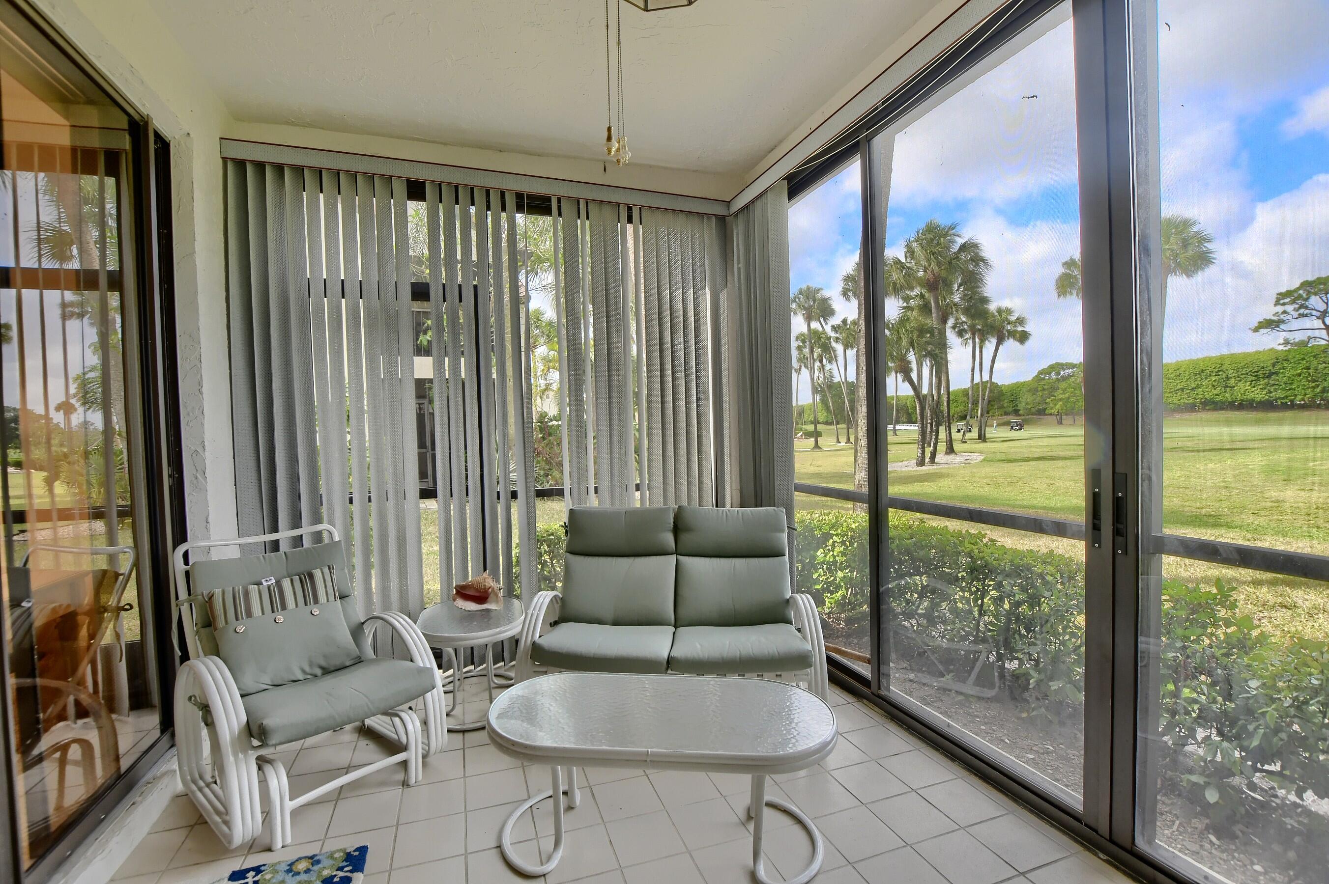 7896 Seville Place, Unit 1501 Boca Raton, FL 33433 - Photo 15 of 32 a living room with furniture and a floor to ceiling window