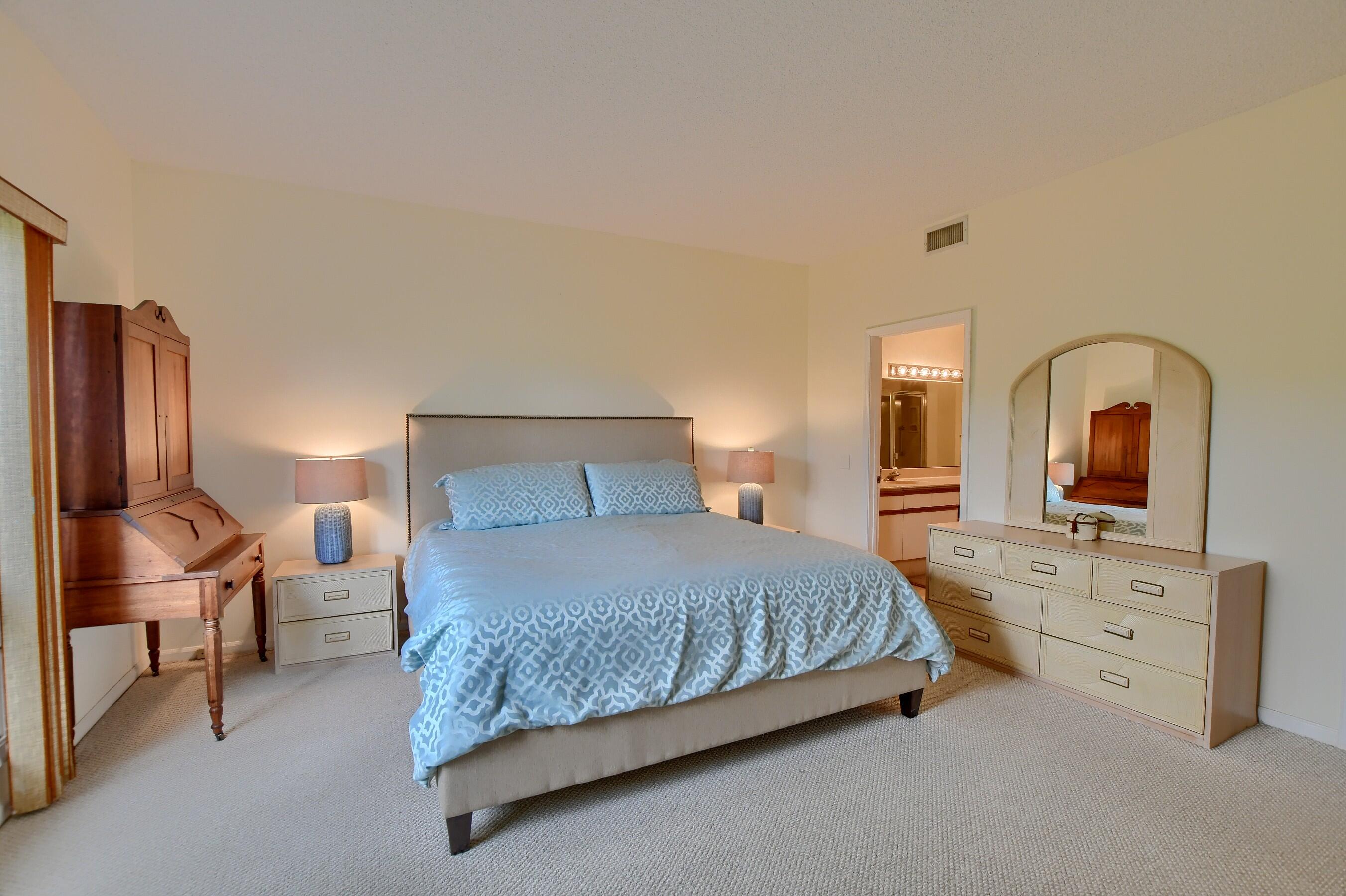 7896 Seville Place, Unit 1501 Boca Raton, FL 33433 - Photo 17 of 32 a bedroom with a bed and a dresser