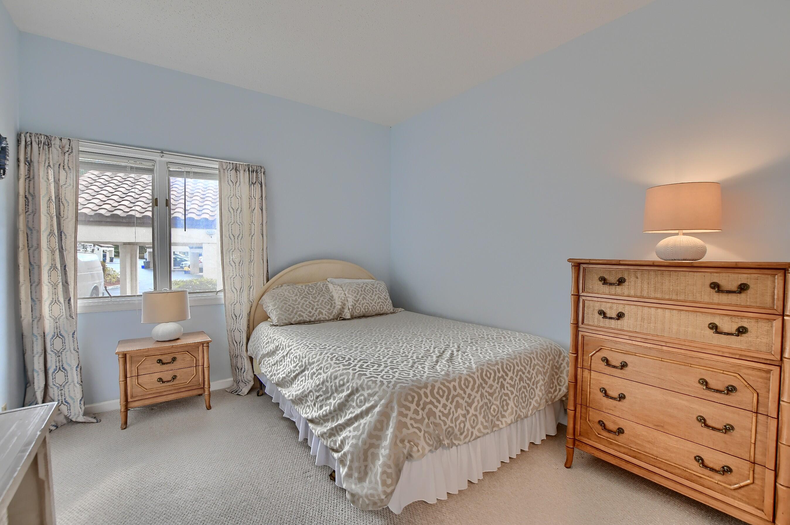 7896 Seville Place, Unit 1501 Boca Raton, FL 33433 - Photo 23 of 32 a bedroom with a bed and a dresser