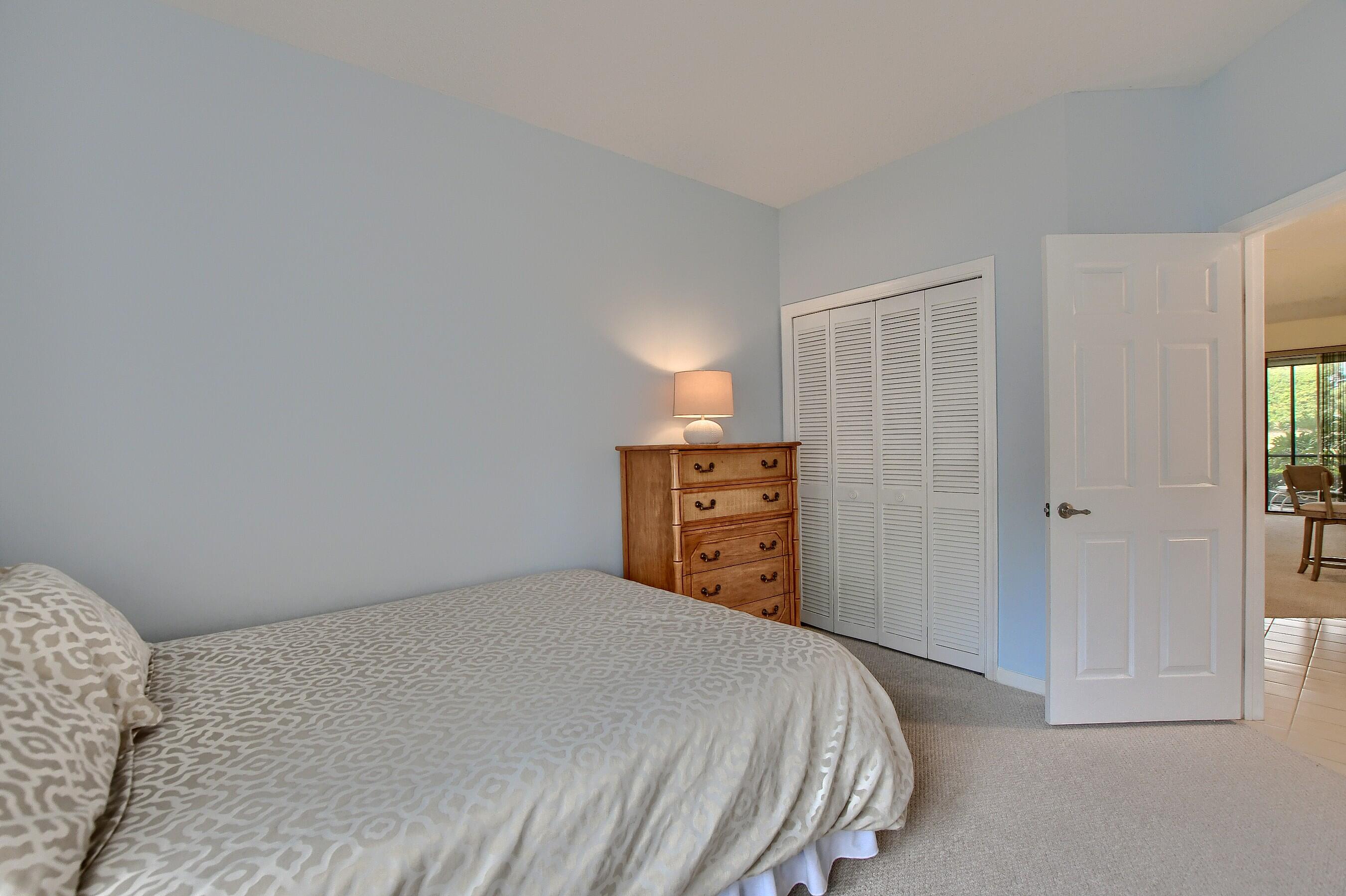 7896 Seville Place, Unit 1501 Boca Raton, FL 33433 - Photo 24 of 32 a bedroom with a bed and a closet