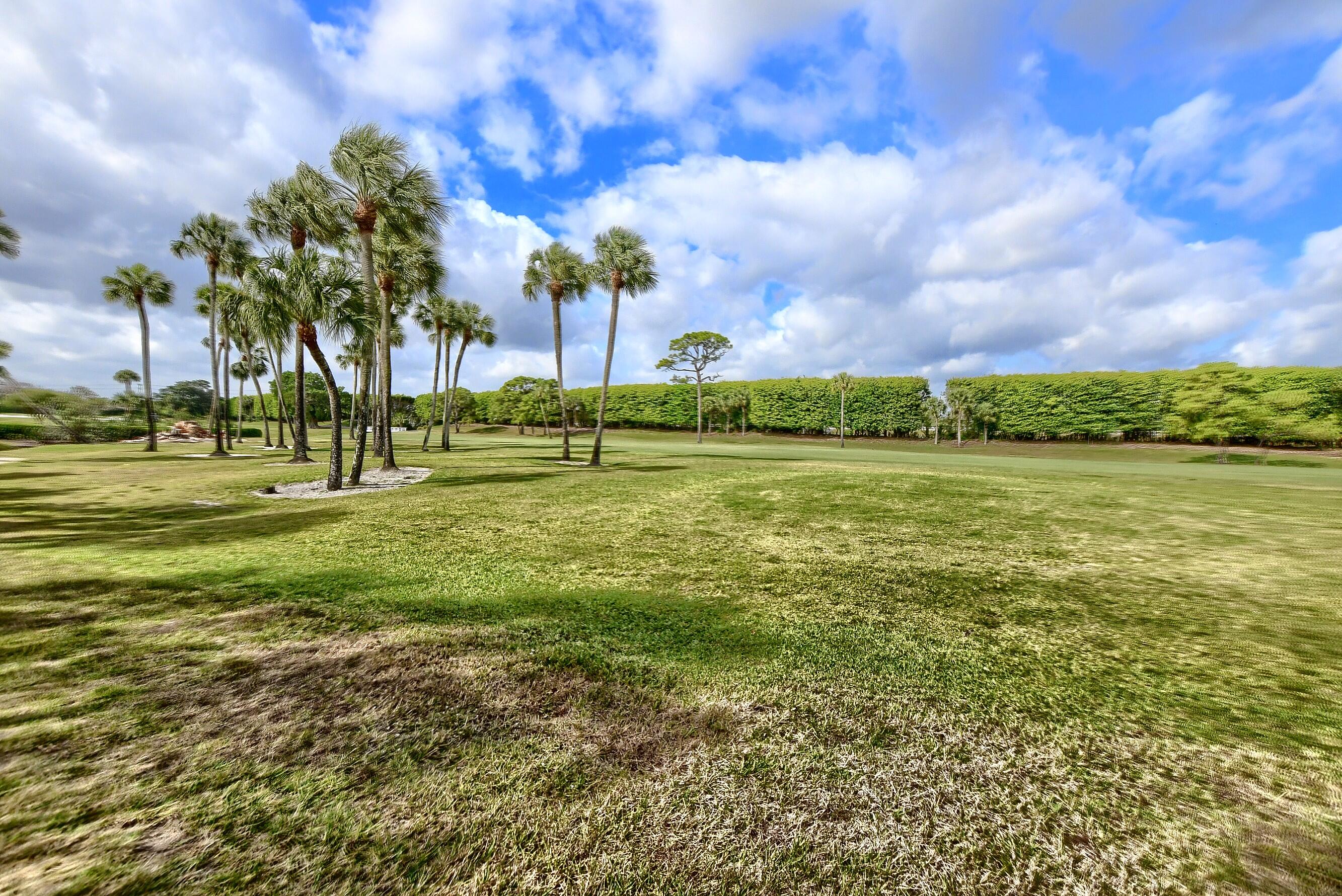 7896 Seville Place, Unit 1501 Boca Raton, FL 33433 - Photo 27 of 32 a view of a green field with houses in the background