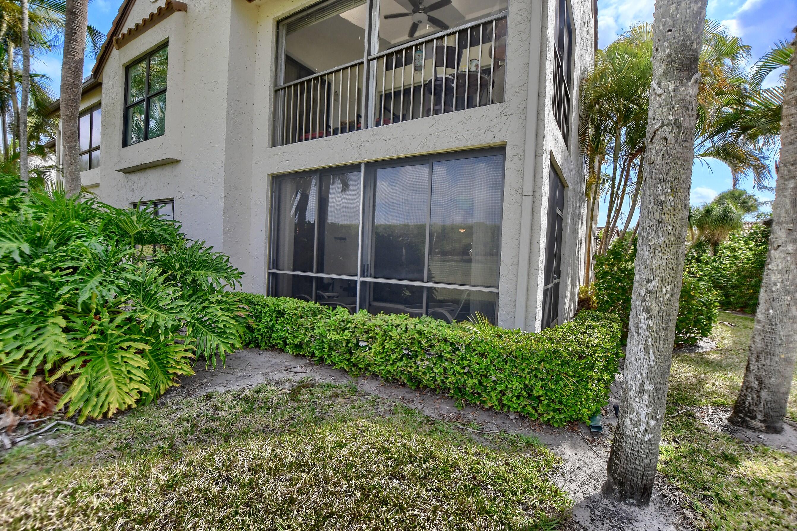 7896 Seville Place, Unit 1501 Boca Raton, FL 33433 - Photo 29 of 32 a view of a house with a flower garden