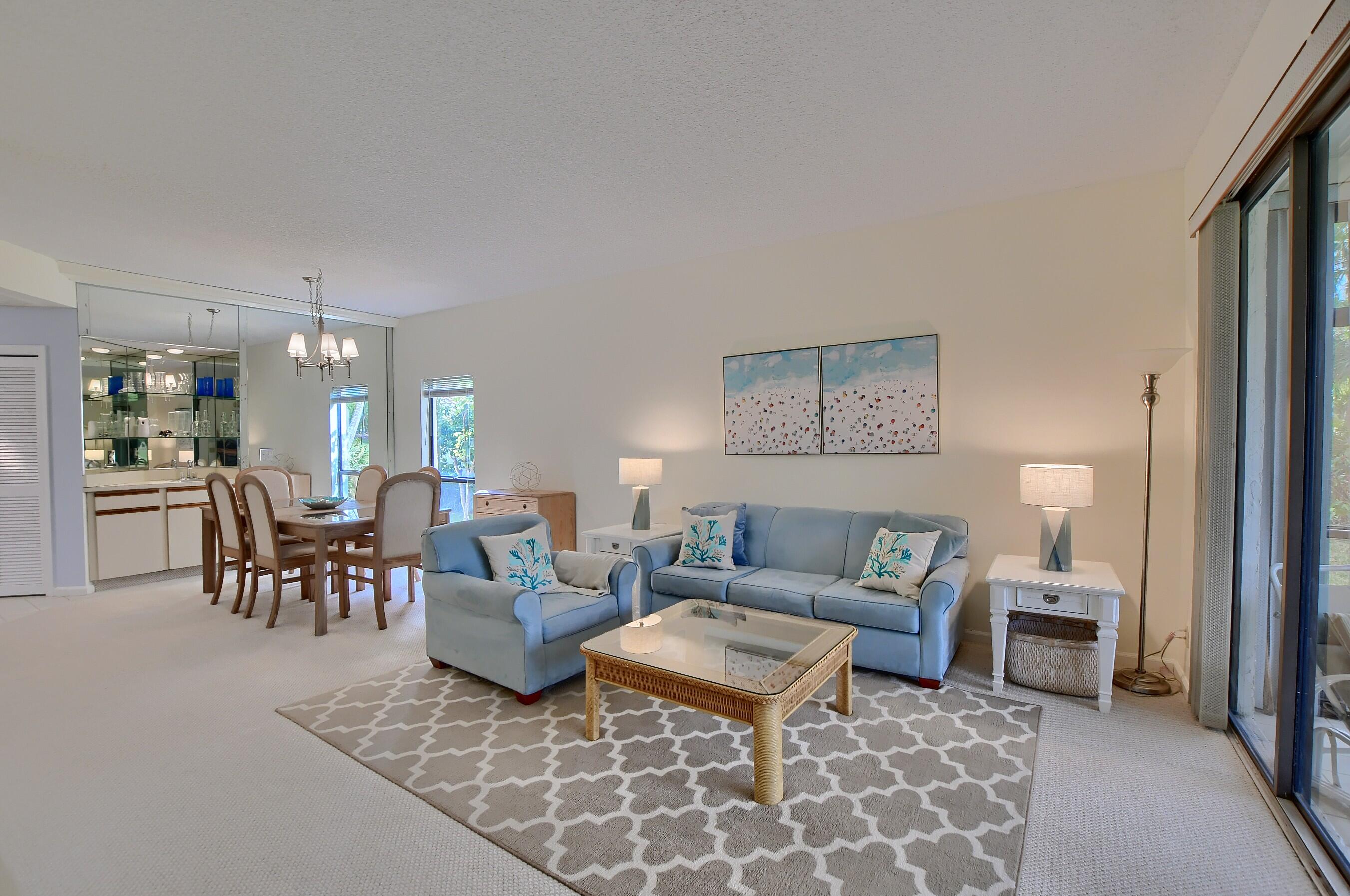 7896 Seville Place, Unit 1501 Boca Raton, FL 33433 - Photo 6 of 32 a living room with furniture and a table