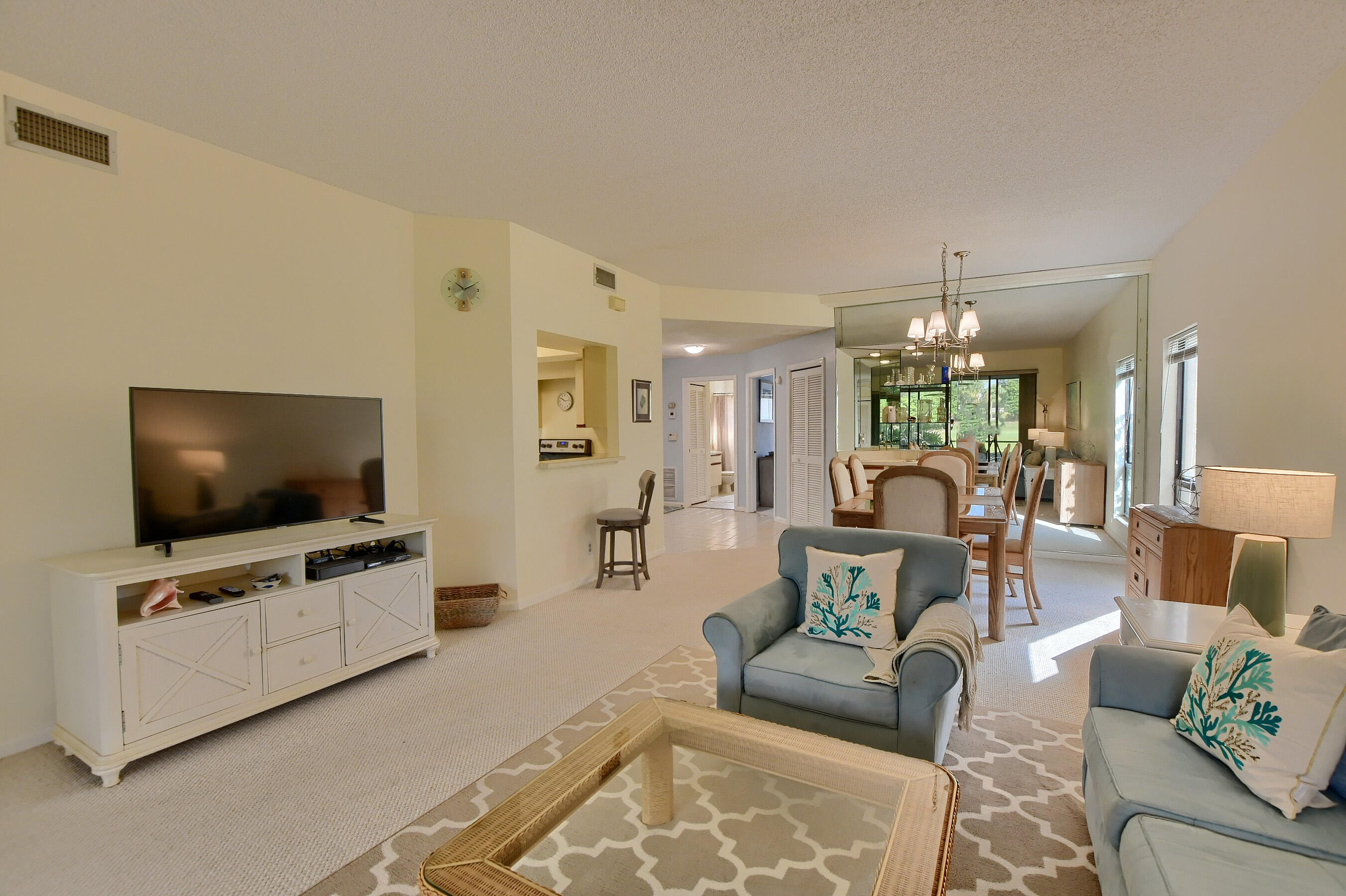 7896 Seville Place, Unit 1501 Boca Raton, FL 33433 - Photo 7 of 32 a living room with furniture and a flat screen tv