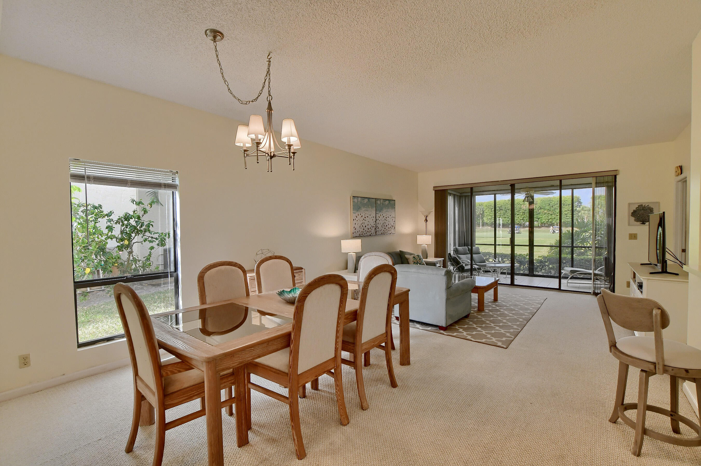 7896 Seville Place, Unit 1501 Boca Raton, FL 33433 - Photo 8 of 32 a dining room with furniture and chandelier