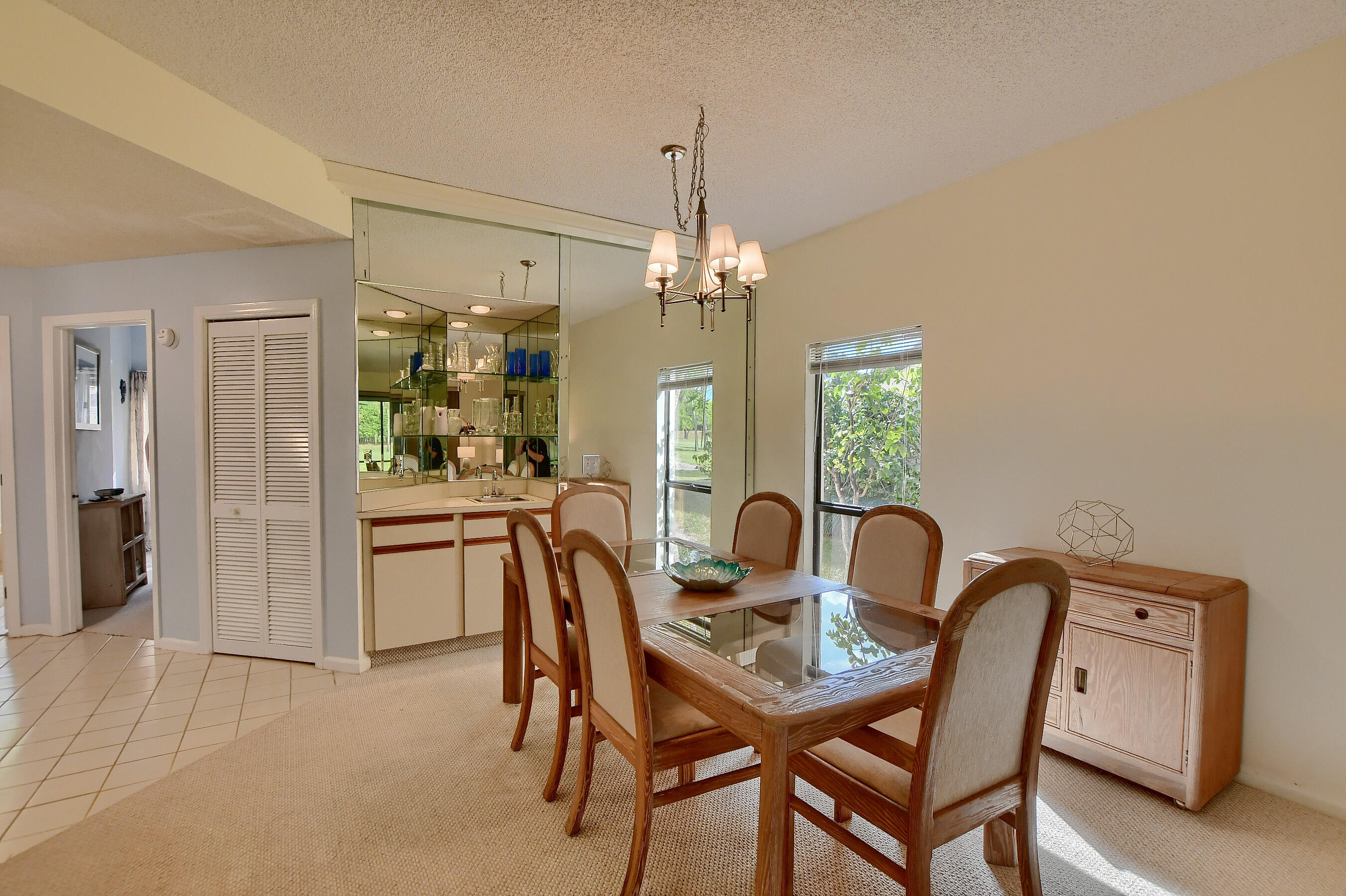 7896 Seville Place, Unit 1501 Boca Raton, FL 33433 - Photo 9 of 32 a view of a dining room with furniture and chandelier